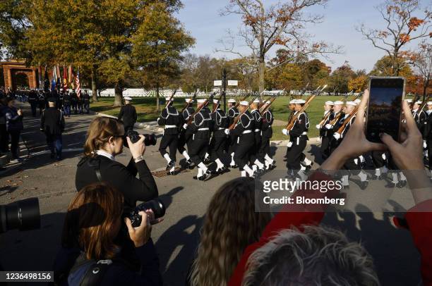 Troops march during a full honors procession honoring the centennial anniversary of the Tomb of the Unknown Soldier at Arlington National Cemetery in...