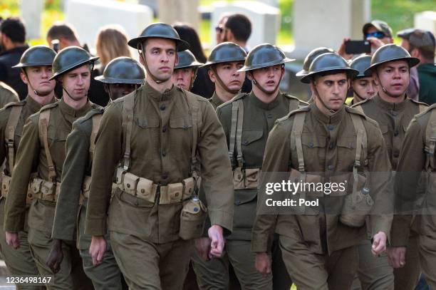 Troops march during a joint full honors procession evoking the original 1921 funeral procession of a World War I unknown soldier, in commemoration of...