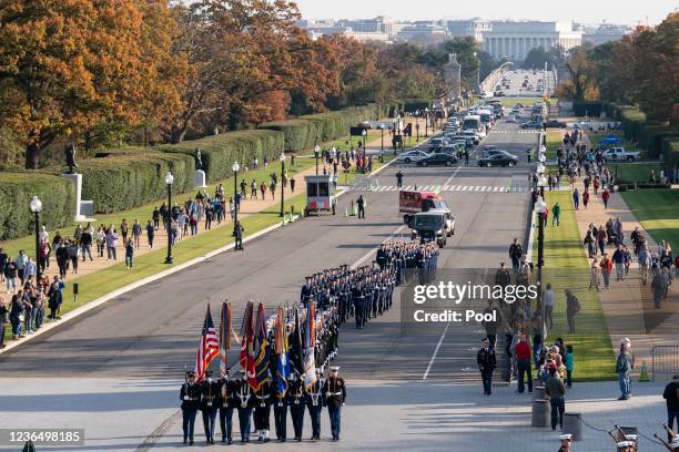 Troops march during a full honors procession commemorating the 100th anniversary of the Tomb of the Unknown Soldier on November 11, 2021 at Arlington...