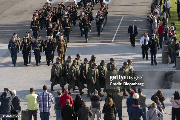 Troops march during a full honors procession honoring the centennial anniversary of the Tomb of the Unknown Soldier at Arlington National Cemetery in...