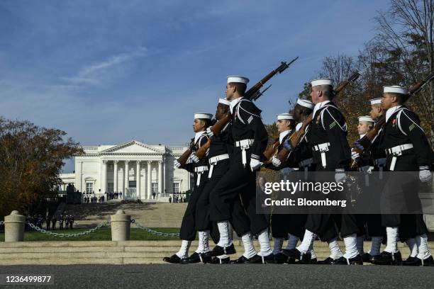 Troops march during a full honors procession honoring the centennial anniversary of the Tomb of the Unknown Soldier at Arlington National Cemetery in...