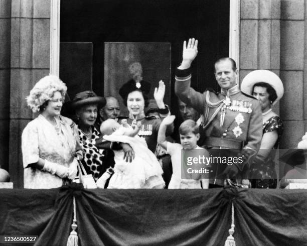 Queen Elizabeth II and Prince Philip Duke of Edinburgh flanked by their children Andrew and Edward and Elizabeth the Queen mother wave to the crowd...