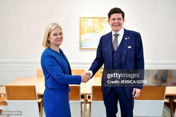 Sweden's Minister of Finance Magdalena Andersson and head of the Social Democratic Party shakes hands with Sweden's speaker of parliament Andreas...