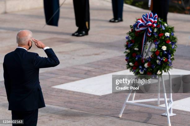President Joe Biden salutes before placing a wreath during a centennial ceremony at the Tomb of the Unknown Soldier in Arlington National Cemetery on...