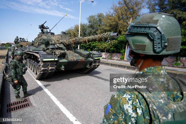 Soldiers stand guard as Tanks are deployed during a shore defense operation as part of a military exercise simulating the defense against the...