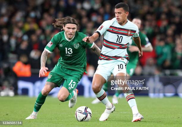 Republic of Ireland's midfielder Jeff Hendrick vies with Portugal's midfielder Matheus Nunes during the FIFA World Cup Qatar 2022 qualifying round...