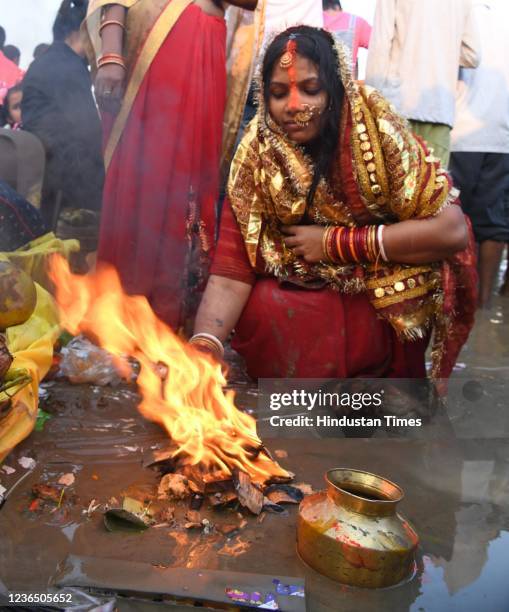 Devotees perform rituals on the occasion of Chhath Puja at Digha ghat on November 11, 2021 in Patna, India. Chhath is celebrated after Diwali by...