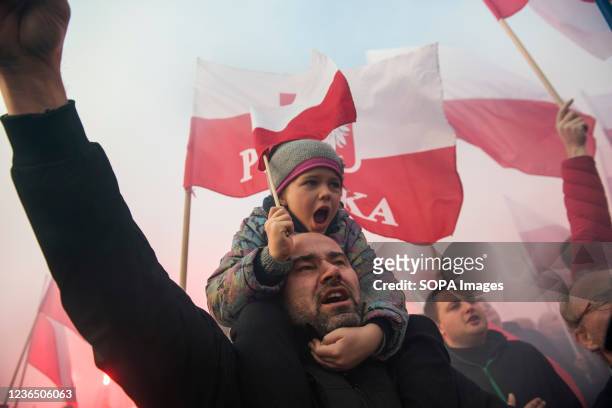 Man with his daughter on the shoulders chant slogans during the Independence March. Poland's National Independence Day marks the anniversary of the...