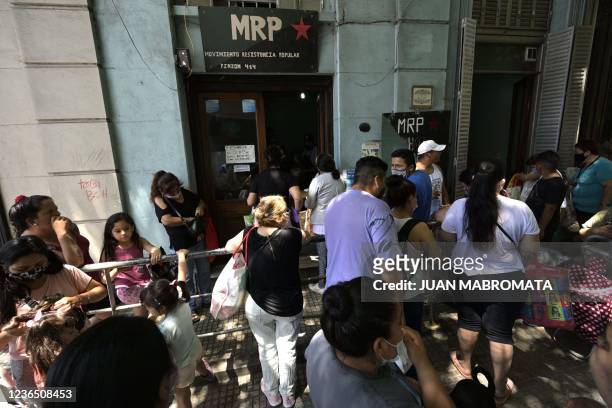 People queue to receive a free meal at a community kitchen of the MRP in La Boca neighborhood, Buenos Aires, Argentina, on November 4, 2021. -...