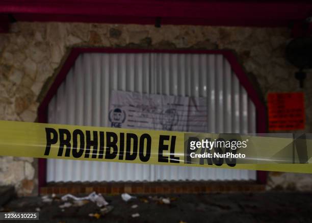 Police security tape around a local restaurant in the center of Tulum, where a fatal inter-gang shootout took place on October 22 in which two...