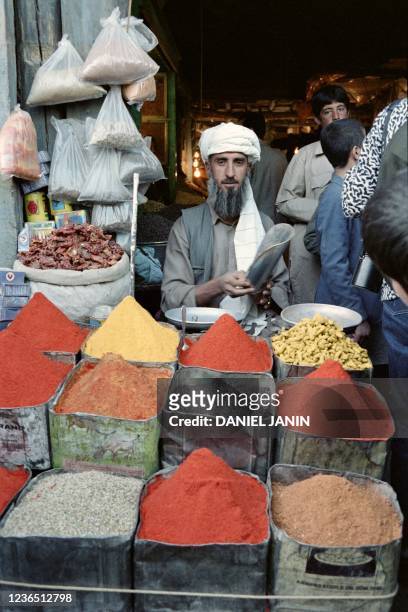 An Afghan man sells spices at the Kabul market, on October 17, 1986 during the Soviet-Afghan war.