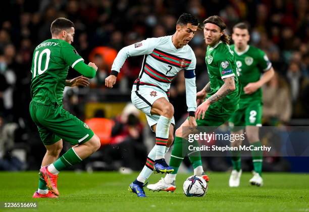 Dublin , Ireland - 11 November 2021; Cristiano Ronaldo of Portugal in action against Matt Doherty, left, and Jeff Hendrick of Republic of Ireland...