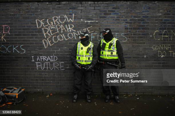 Police are seen standing next to chalked graffiti outside the entrance to the COP26 site on November 12, 2021 in Glasgow, United Kingdom. As World...