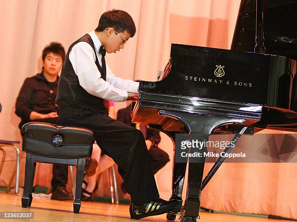 Pianist Lang Lang and US Young Scholar Derek Wang perform at PS 334 - The Anderson School on January 3, 2011 in New York City.