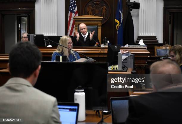 Judge Bruce Schroeder, center back, talks about the charges against Kyle Rittenhouse as Assistant District Attorneys Thomas Binger, front left, and...