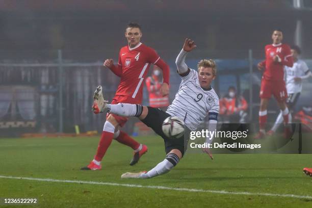 Kamil Kruk of Poland and Jonathan Burkardt of Germany battle for the ball during the 2022 UEFA European Under-21 Championship Qualifier match between...