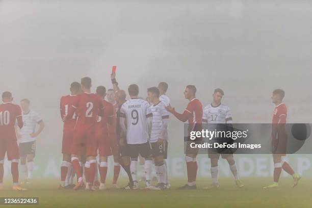 Referee Luis Godinho shows Jean-Manuel Mbom of Germany the red card during the 2022 UEFA European Under-21 Championship Qualifier match between...