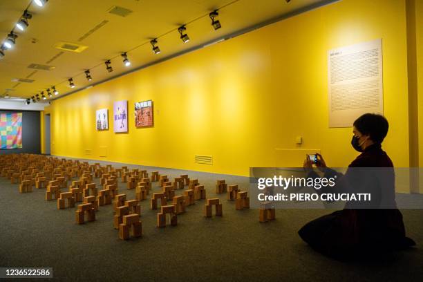 Visitor takes a picture of artworks by Chinese dissident artist Badiucao in a room dedicated to Hong Kong, on November 12, 2021 at the exhibition...