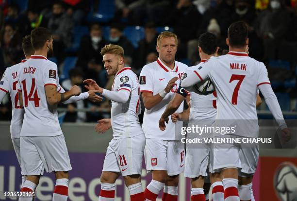 Poland's midfielder Kamil Jozwiak celebrates with teammates after he scored the second goal during the FIFA World Cup Qatar 2022 qualification Group...