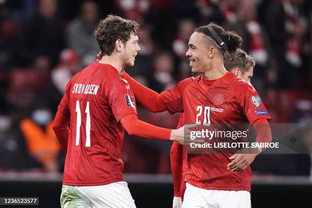 Denmark's forward Andreas Skov Olsen celebrates scoring the opening goal with his teammate Denmark's forward Yussuf Poulsen during the FIFA World Cup...