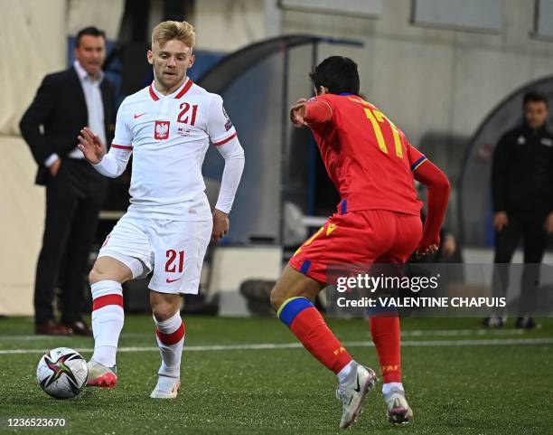 Poland's midfielder Kamil Jozwiak challenges Andorra's defender Joan Cervos as Andorra's coach Koldo Alvarez looks on during the FIFA World Cup Qatar...