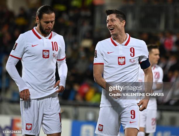 Poland's forward Robert Lewandowski reacts with Poland's midfielder Grzegorz Krychowiak during the FIFA World Cup Qatar 2022 qualification Group I...