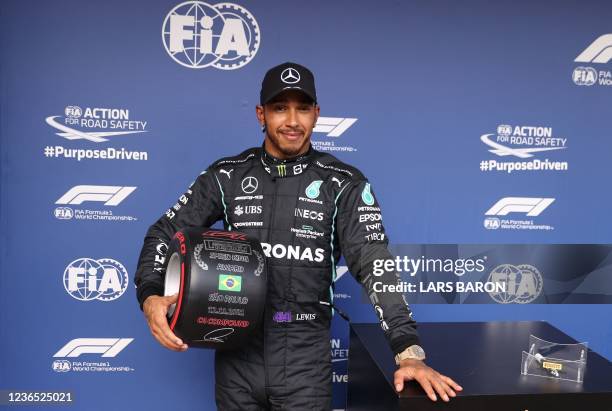 Mercedes' British driver Lewis Hamilton poses after winning the qualifying session for Brazil's Formula One Sao Paulo Grand Prix, at the Autodromo...