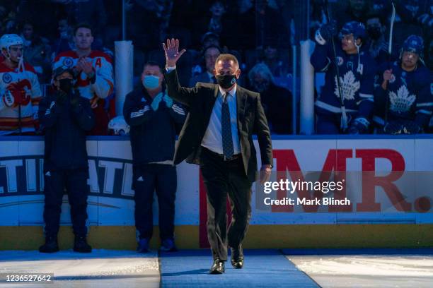 Hockey Hall of Fame Class of 2020 Inductee Ken Holland waves to the crowd during a ceremony before the Toronto Maple Leafs face the Calgary Flames at...