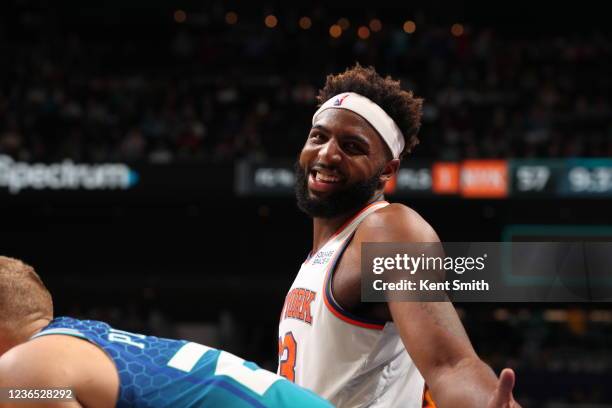 Mitchell Robinson of the New York Knicks smiles during the game against the Charlotte Hornets on November 12, 2021 at Spectrum Center in Charlotte,...