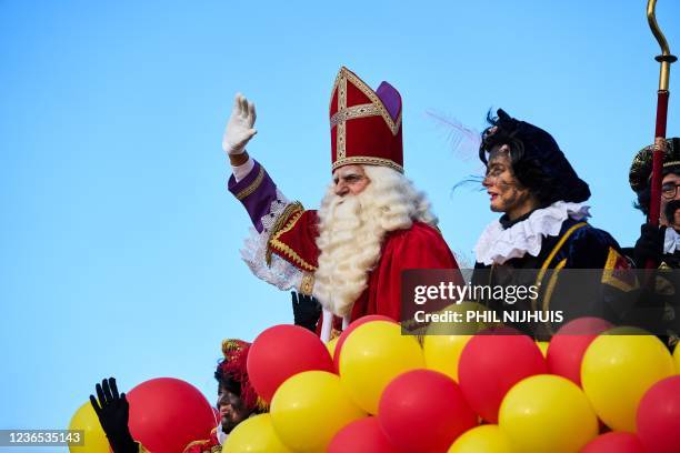 'Sinterklaas' is greeted by wellwishers as he arrives in the harbour of Scheveningen, The Hague on November 13 ahead of Christmas festivities. -...