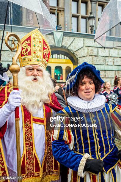 "Sinterklaas" and Zwarte Piet are greeted by wellwishers upon their arrival ahead of Christmas festivities in Antwerp, on November 13 2021. -...