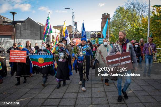 Indigenous leaders hold an inauguration march from Mclennan Arch in Glasgow Green Park along the river Clyde to the COP26 conference centre to mark...