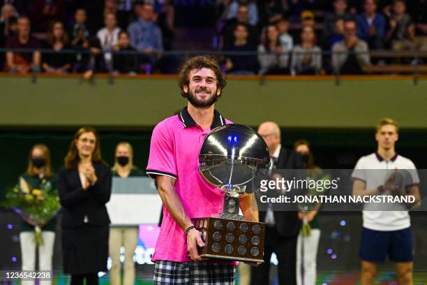 S Tommy Paul poses with the trophy after winning his singles final match against Canada's Denis Shapovalov at the ATP Stockholm Open tennis...