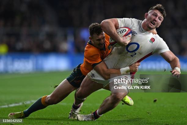 England's number 8 Tom Curry is tackled by Australia's scrum-half Nic White during the Autumn International friendly rugby union match between...