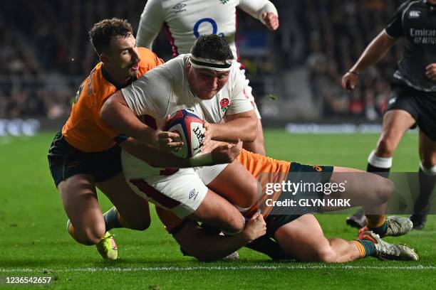 Australia's scrum-half Nic White knocks the ball out of the arms of England's hooker Jamie George preventing a try during the Autumn International...