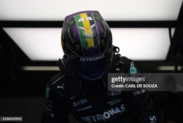 Picture of the helmet of Mercedes' British driver Lewis Hamilton taken as he gets into his car at the team's garage in pit lane during the free...