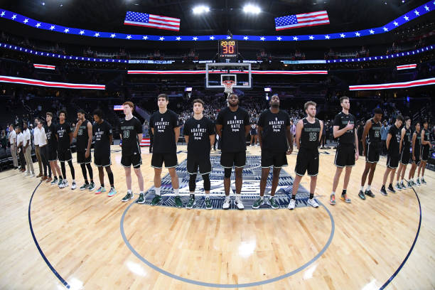 The Dartmouth Big Green line up for the Nationals Anthem before a college basketball game against the Georgetown Hoyas at Capital One Arena on...