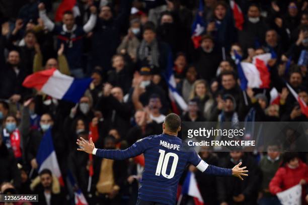 France's forward Kylian Mbappe celebrates after scoring a goal during the FIFA World Cup 2022 qualification football match between France and...