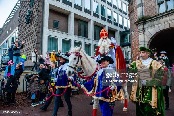 St. Nicholas is arriving to the city riding his white horse and accompanied for the first time by St Nicholas helpers without blackface makeup, and...
