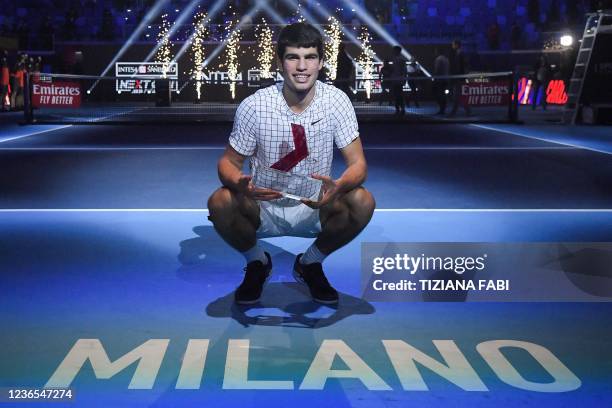 Spain's Carlos Alcaraz poses with his trophy after winning against USA's Sebastian Korda during their final match at the Next Generation ATP Finals...