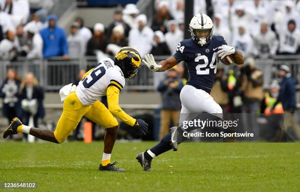 Penn State running back Keyvone Lee appears to do the Heisman Trophy pose while avoiding Michigan defensive back Rod Moore during the Michigan...