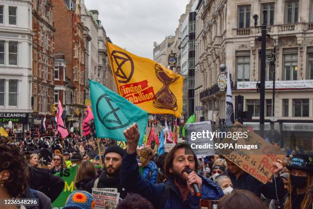 Demonstrator chants slogans through a microphone during the protest. Extinction Rebellion demonstrators marched through the city, disrupting the Lord...