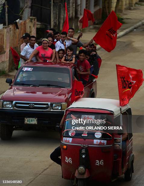 Supporters of Honduran presidential candidate for the Libertad y Refundacion party Xiomara Castro de Zelaya ride on a truck to attend a rally in La...