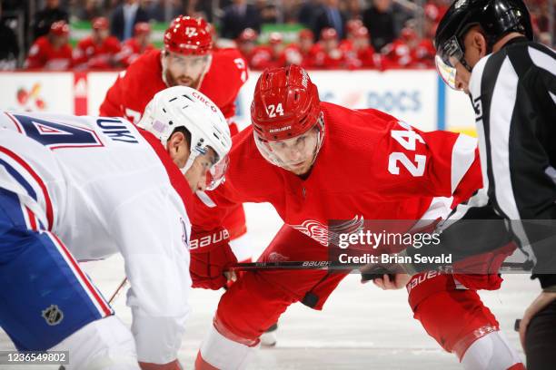 Nick Suzuki of the Montreal Canadiens and Pius Suter of the Detroit Red Wings line up for a face-off during the first period of an NHL game at Little...