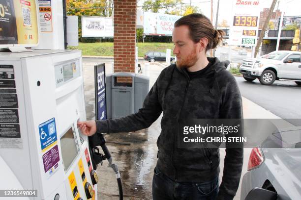 Phil Johnson gets gas in Wilmington, Delaware on November 12, 2021 - Following the latest inflation report, Joe Manchin, a centrist senator whose...