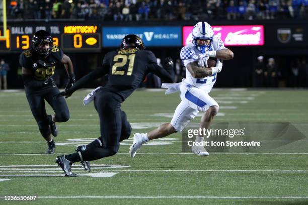 Kentucky Wildcats running back Chris Rodriguez Jr. Runs the ball in front of Vanderbilt Commodores safety Maxwell Worship during a game between the...