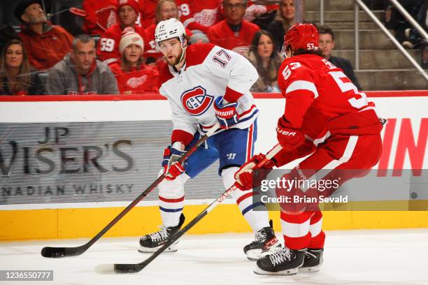 Josh Anderson of the Montreal Canadiens skates with the puck in front of Moritz Seider of the Detroit Red Wings during the second period of an NHL...