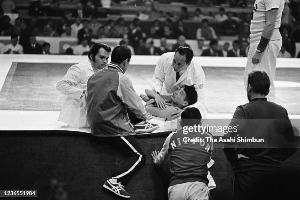 Yojiro Uetake of Japan receives medical attention during the Wrestling Freestyle 57kg round 7 against Aboutaleb Talebi of Iran during the Mexico City...