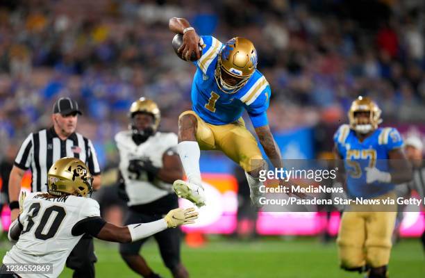 Pasadena, CA Quarterback Dorian Thompson-Robinson of the UCLA Bruins leaps for the first down against the Colorado Buffaloes in the third quarter of...