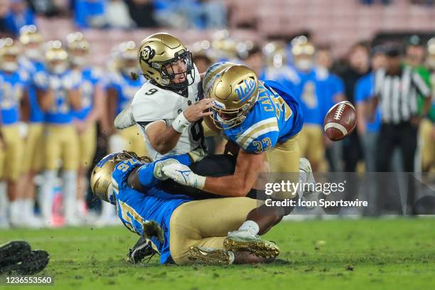 Linebacker Bo Calvert and defensive lineman Odua Isibor tackle Colorado quarterback Drew Carter for a fumble during the second half of an NCAA...